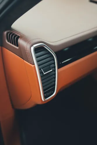 A clean leather dashboard and polished air vent trim.