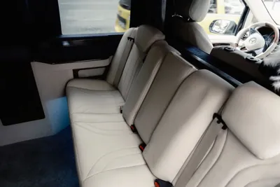 Clean cream-coloured leather seats in a passenger van.